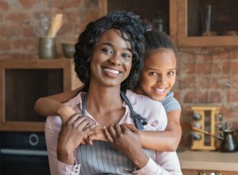 Close mother and daughter bonding at kitchen