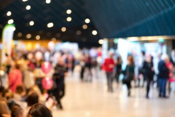 Blurred crowd of people in modern interior during event