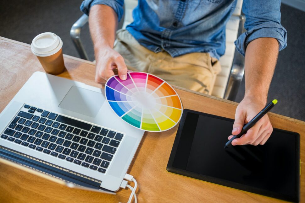 Designer working with colour wheel and digitizer in the office