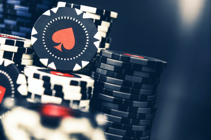 Poker Chips Stacked On Casino Table.