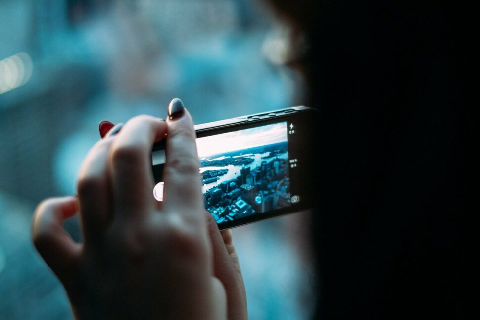 An image showing a hand holding a phone with a blue screen. 