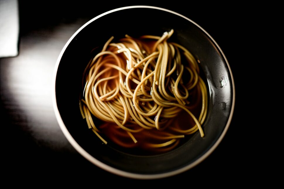 A bowl holding soba noodles.