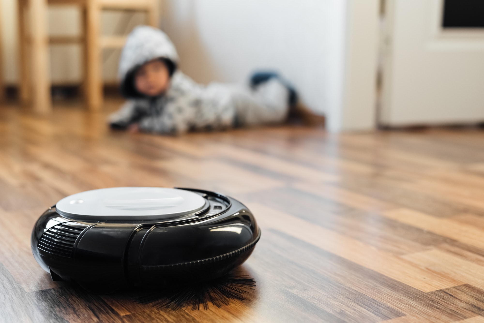 Online shopping trends: robotic vacuum cleaner on a wood floor