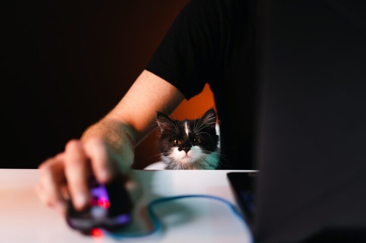 Human hand pressing computer mouse with flash of light on background