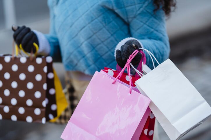 Woman holding shopping bags during the holiday season.